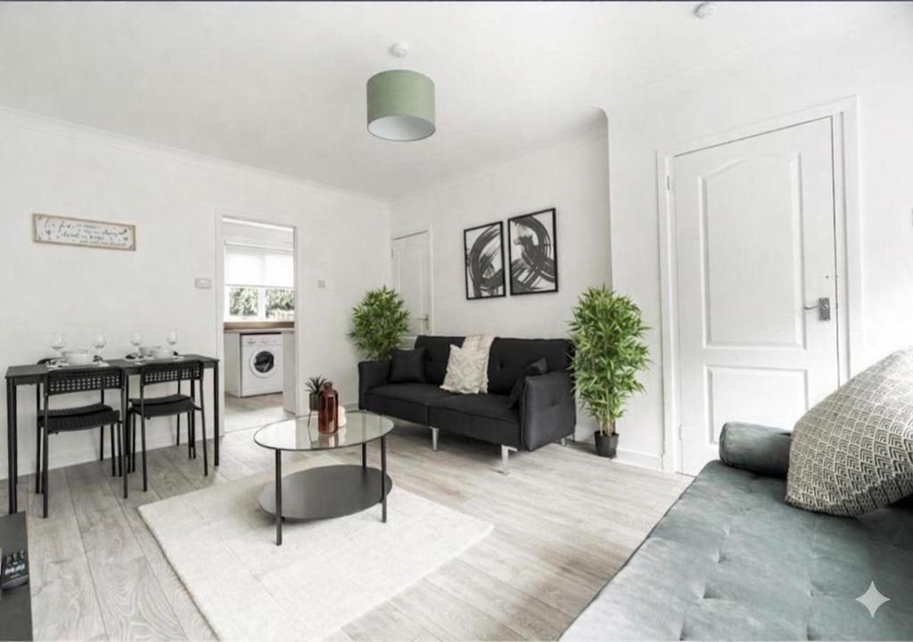 a living room with a couch and a table at Celtic City Stay in Glasgow