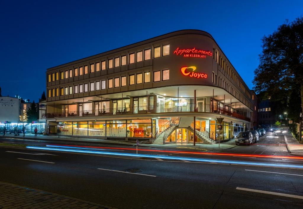 a building with a sign on the side of a street at Appartements am Kleeblatt in Wuppertal