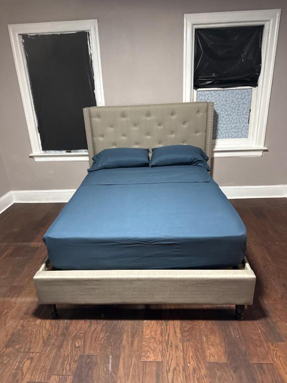 a bed in a room with blue pillows on it at Casa Tabacon CR USA in Trenton