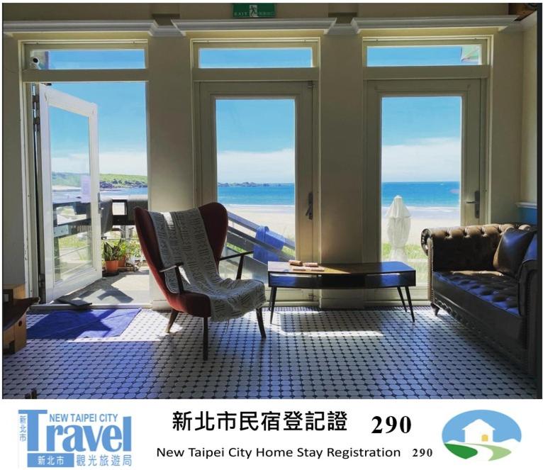 a living room with a view of the ocean at Chill Chill House in Shimen District