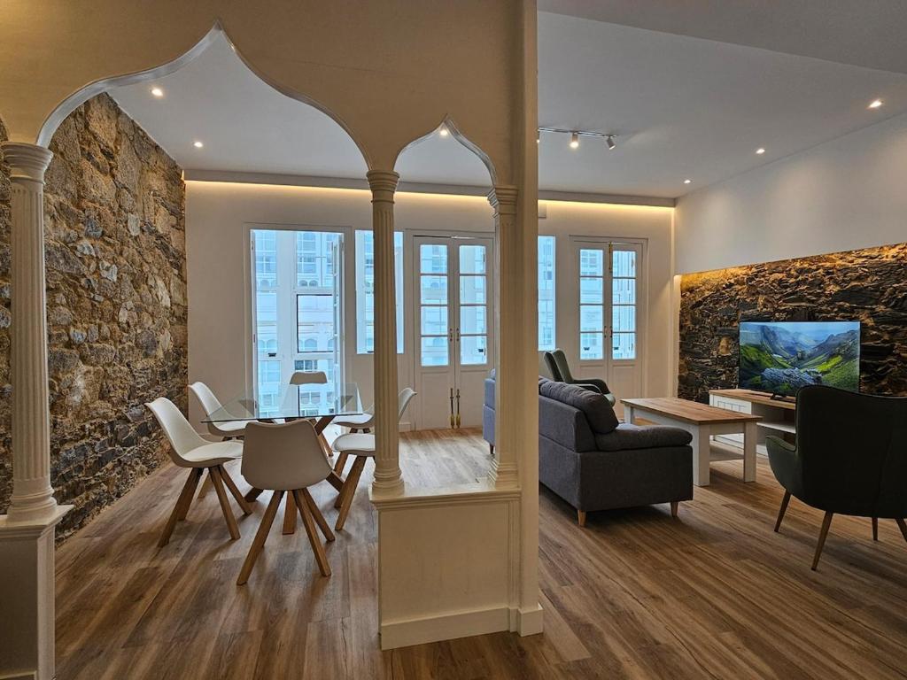 a living room with a stone wall at Apartamento Plaza de Armas 2 in Ferrol
