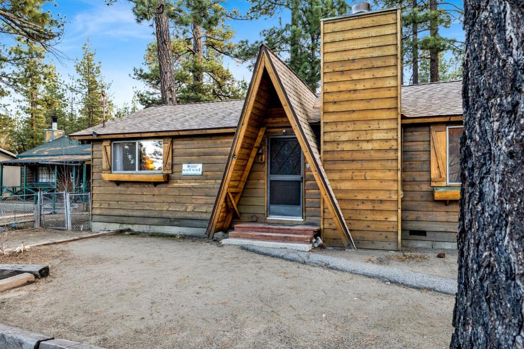 a wooden house with a gambrel roof at 2583-Bernhardt Brown Bungalow in Big Bear City