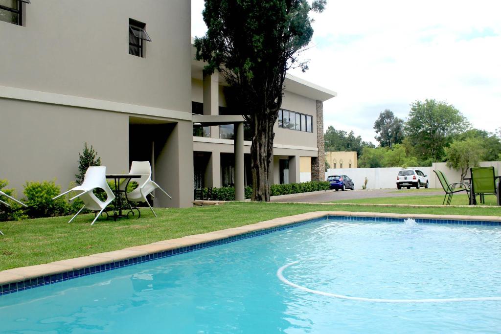 a swimming pool in front of a house at Angel Guest House in Johannesburg