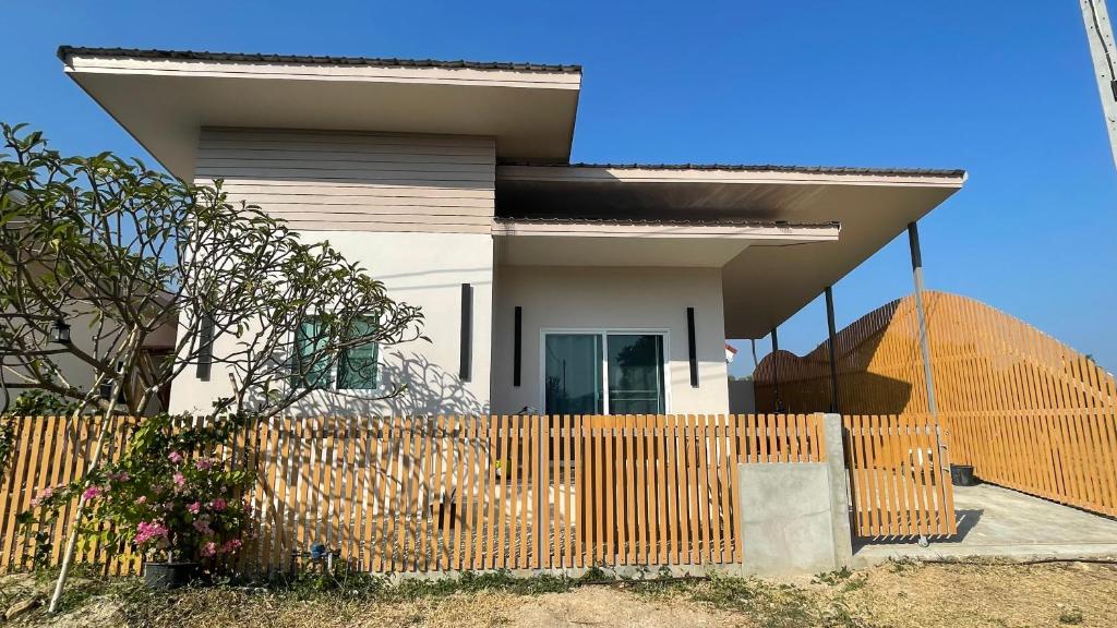 a house with a wooden fence in front of it at Luxe Sands Pran in Ban Nong Ban Kao