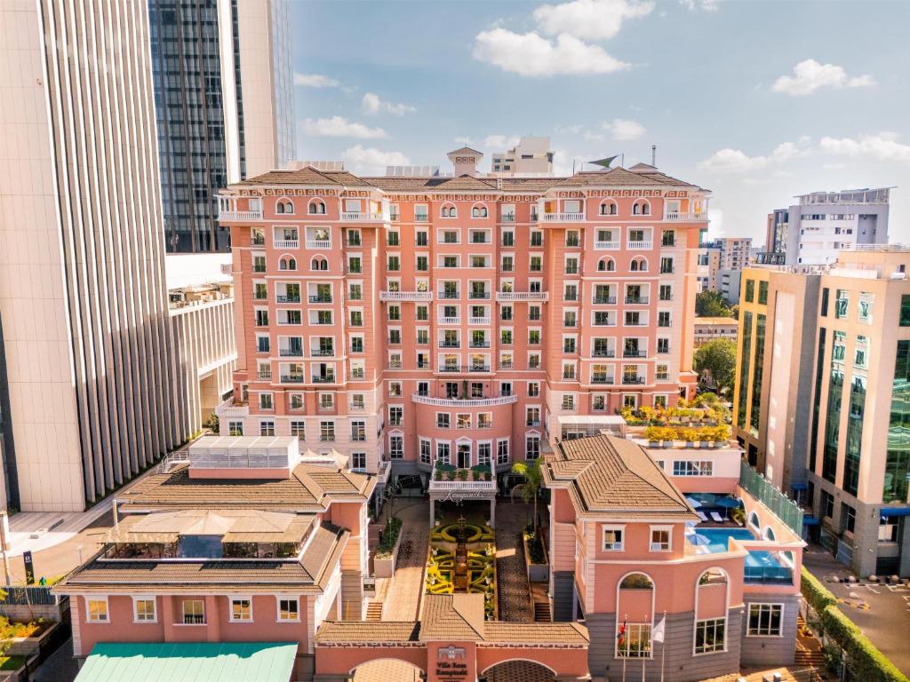 an aerial view of a large pink building in a city at Villa Rosa Kempinski in Nairobi
