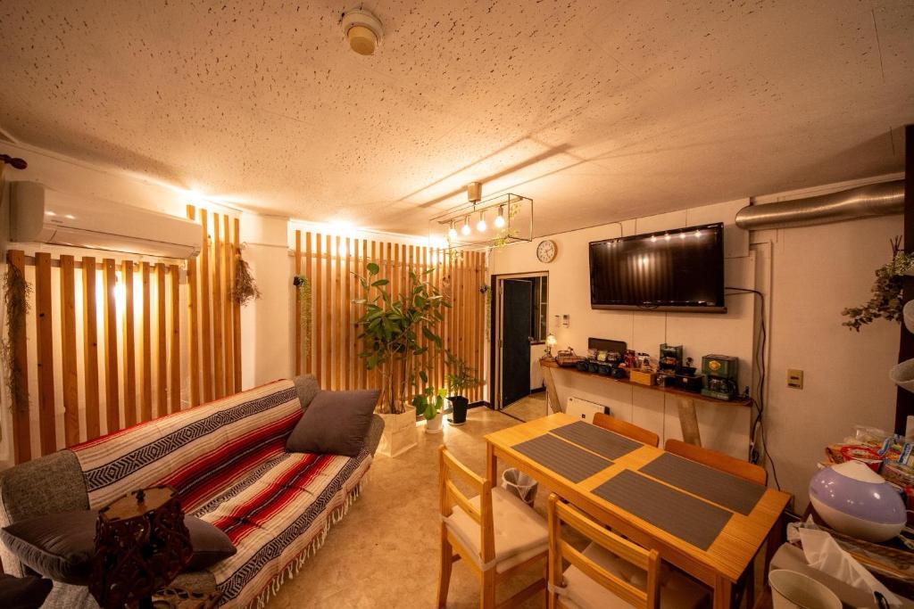 a living room with a couch and a table at SaKuRa B&B in Sakura