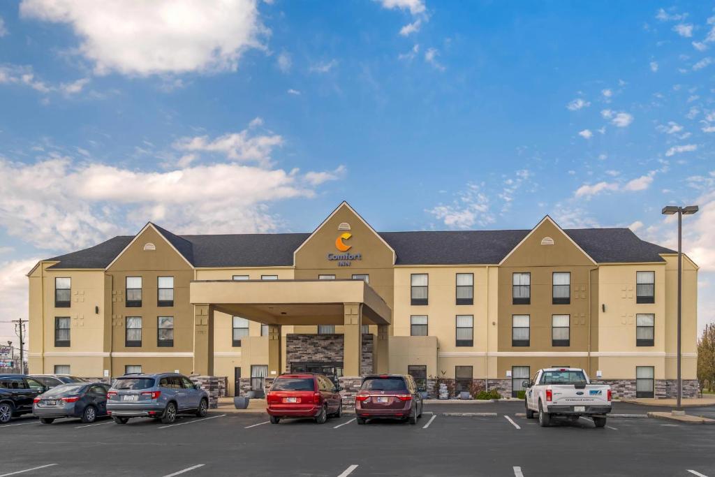 a large building with cars parked in a parking lot at Comfort Inn Madison near Clifty Falls in Madison