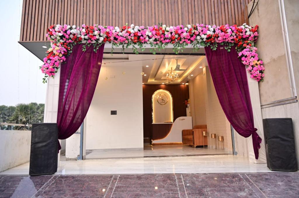 a wedding arch with purple and pink flowers at Hotel RK Royale in Patna