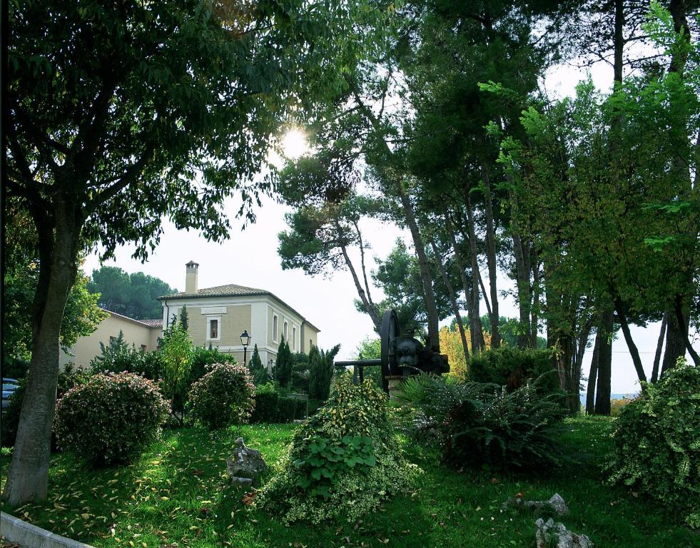 a house in the middle of a yard with trees at Hotel L'Estació in Bocairent