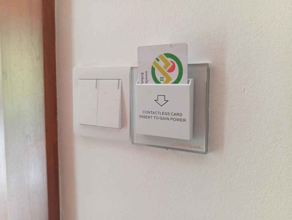 a switch on a wall with a sign on it at Leon Hilltop Resort in Kitulgala
