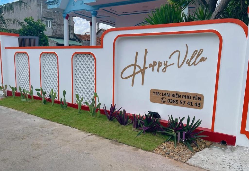 a sign for a happy villa on the side of a sidewalk at Happy Villa in Phú Hiệp