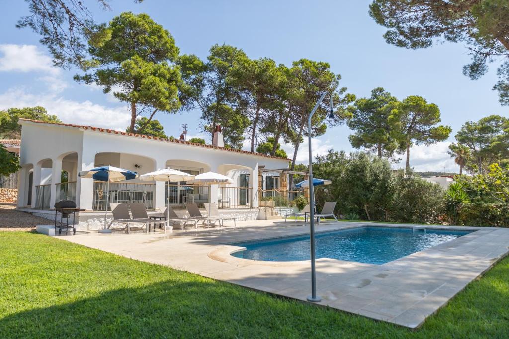 a villa with a swimming pool and a house at Villa Santo Tomas - Gabriela in Santo Tomás