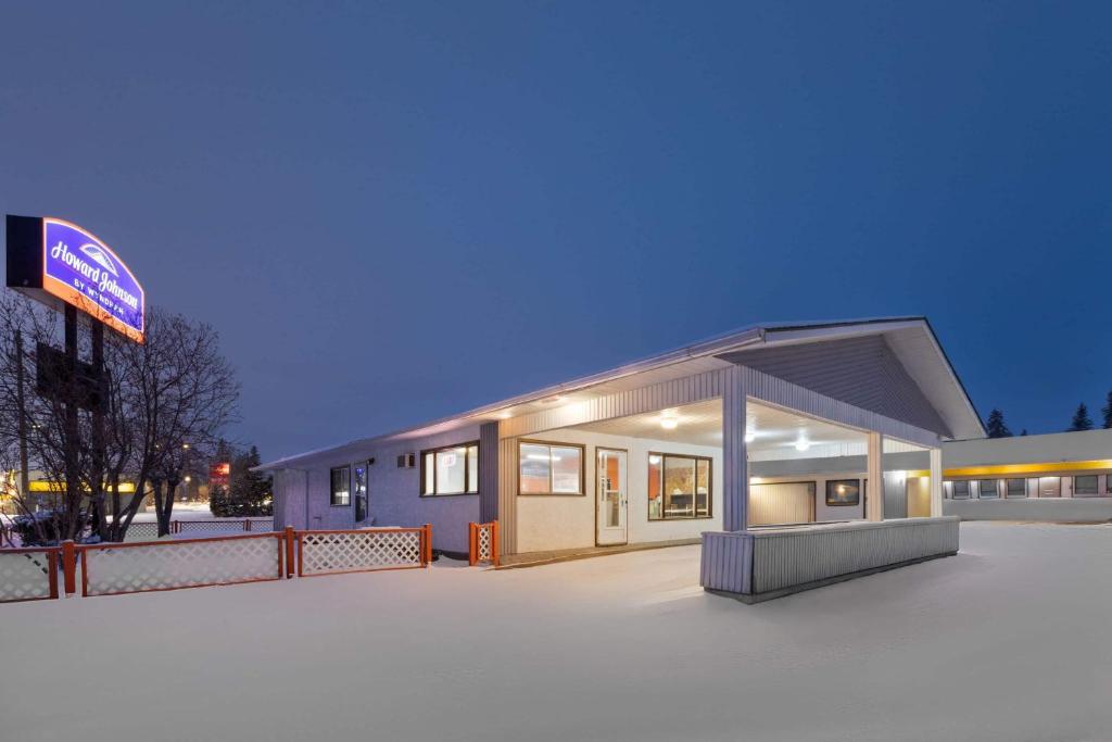 a small building with a sign in front of it at Howard Johnson by Wyndham Edson in Edson
