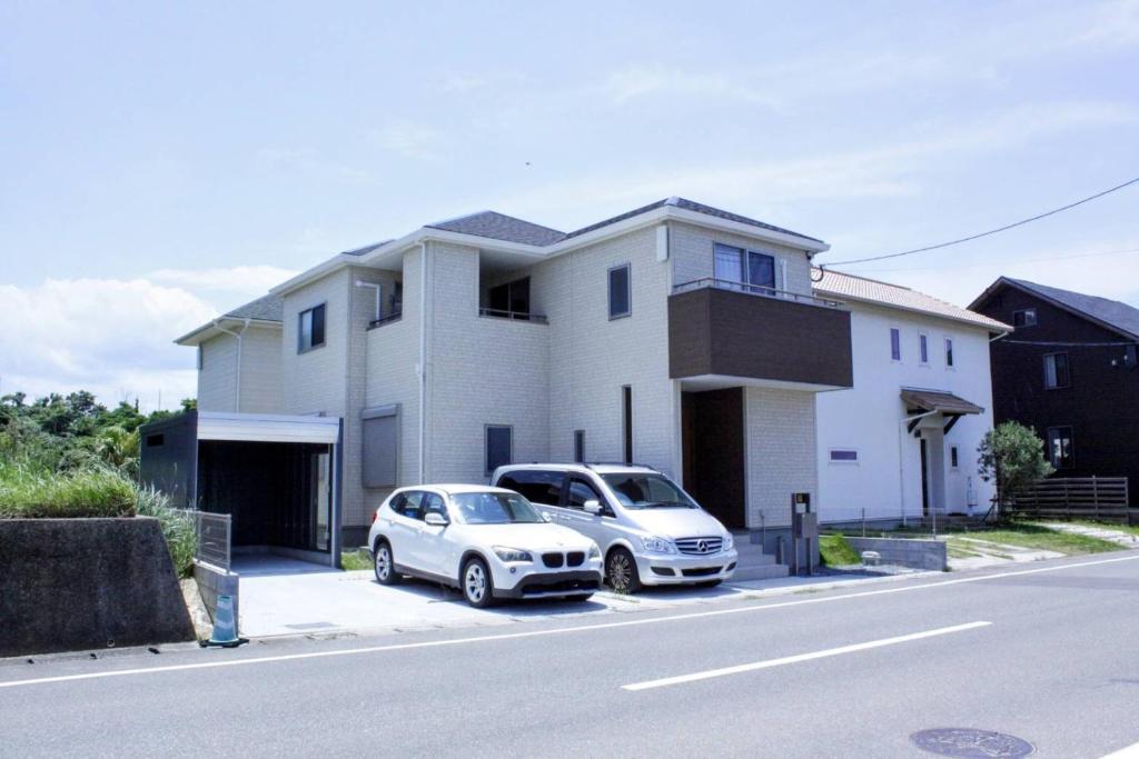 two cars parked in front of a house at ev itoshima in Itoshima