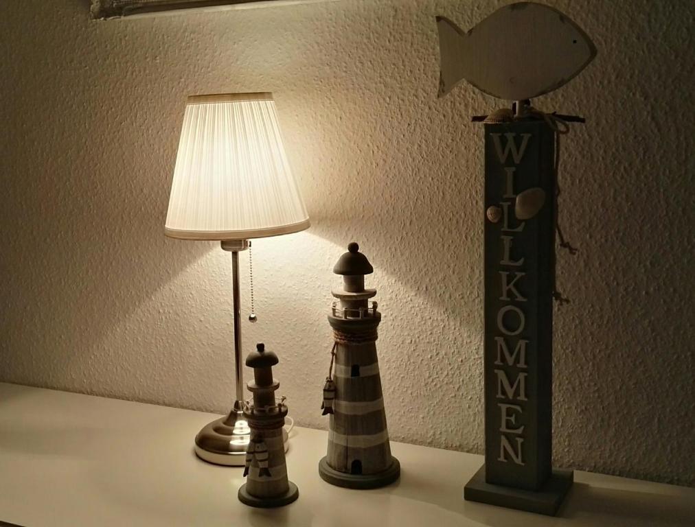 a table with a lamp and two chess pieces on it at Wat(t) ne Wohnung in Büsum