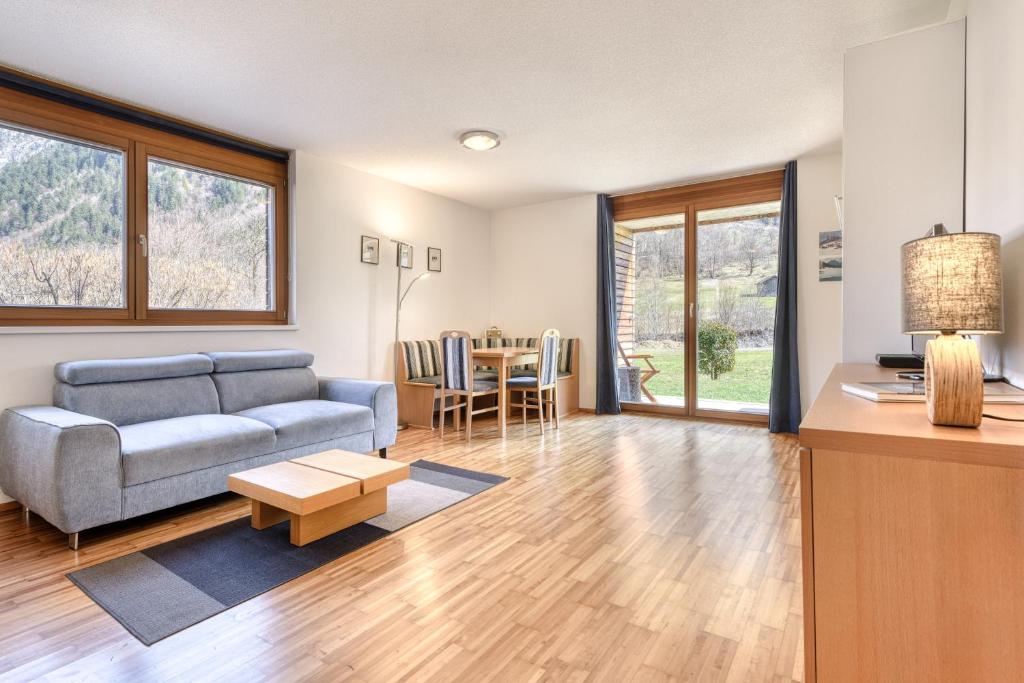 a living room with a couch and a table at Gartenappartement Kirchdorf by A-Appartments in Brand