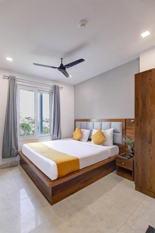 a bedroom with a large bed and a window at Status By Hotel The Emporio in Ghaziabad