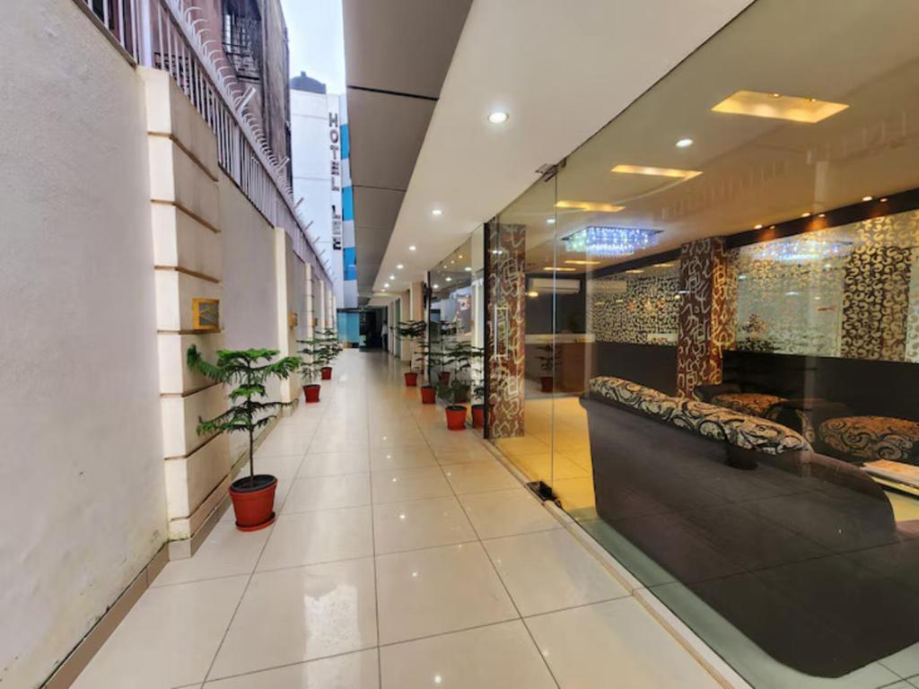 a hallway of a store with potted plants at Hotel Lee International in Kolkata