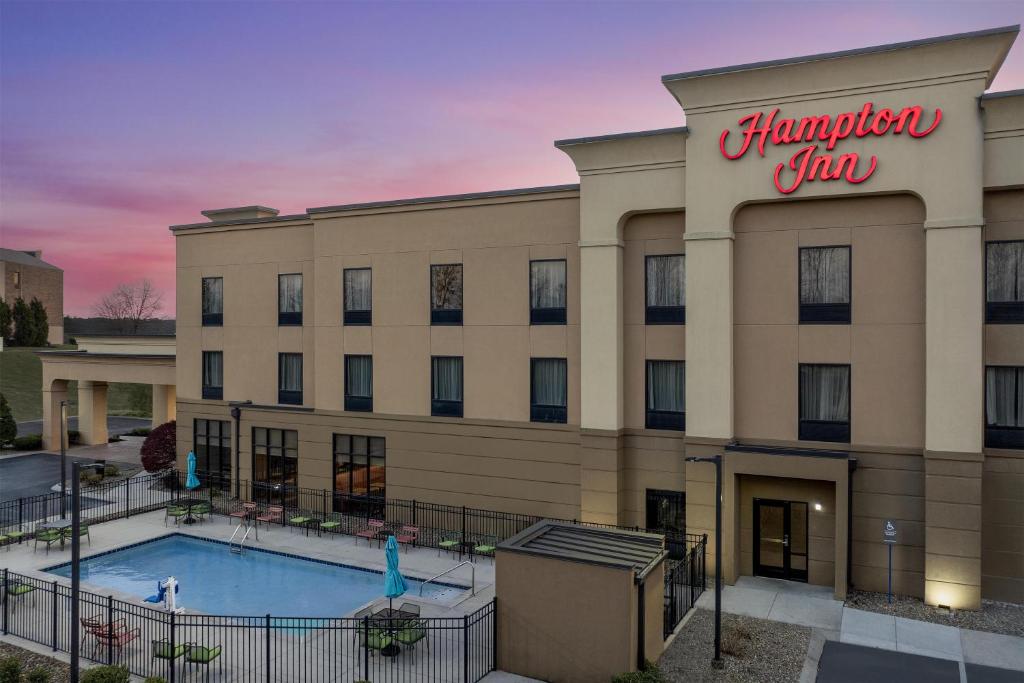 a hotel with a swimming pool in front of a building at Hampton Inn Crossville in Crossville
