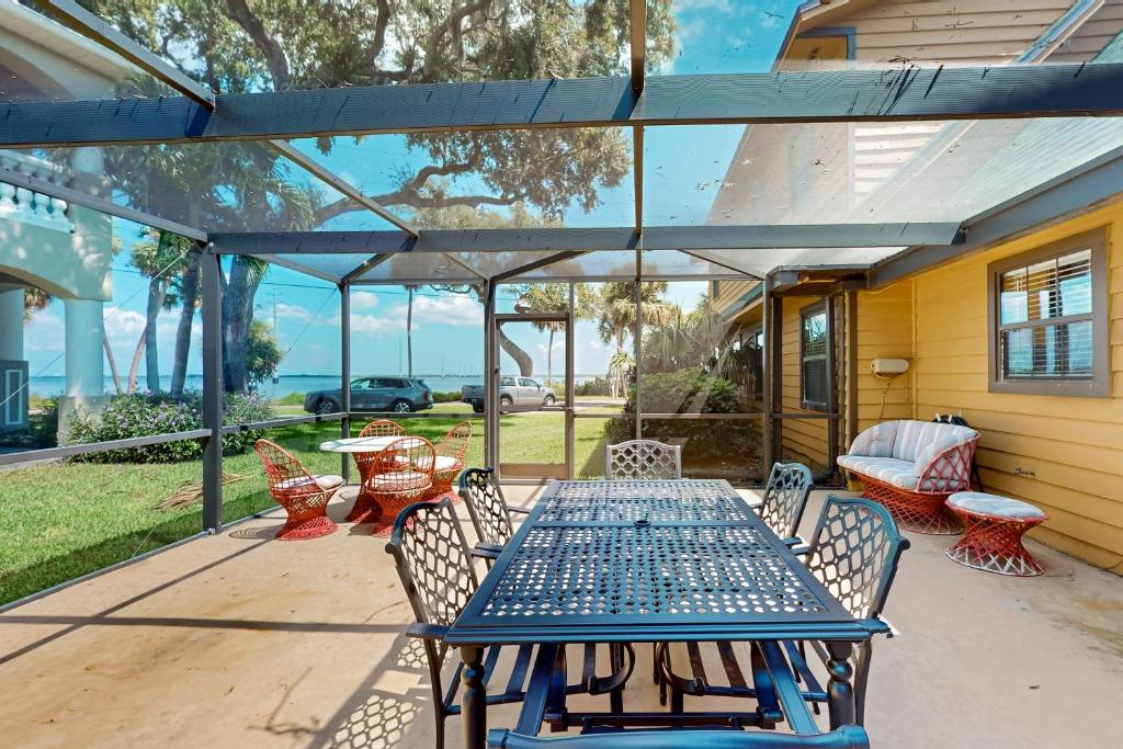 a table and chairs on a patio with a view of the ocean at 3424 Indian River Dr Main in Cocoa