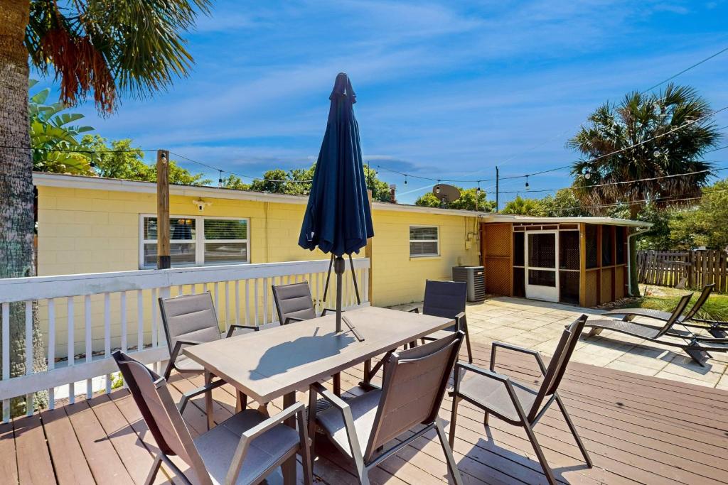 a patio with a table and umbrella on a deck at 2403 Auburn Dr in Cocoa