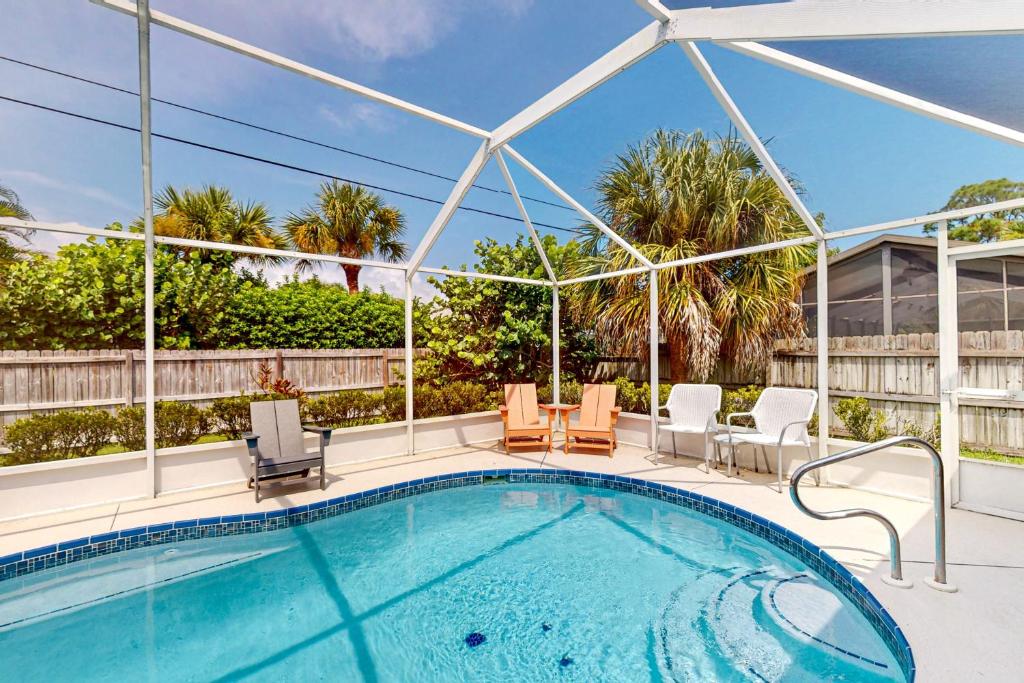 a large swimming pool with chairs at 620 S Easy St in Sebastian