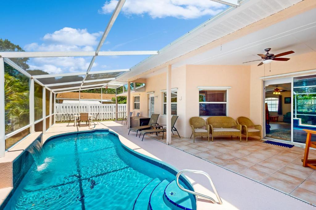 a house with a swimming pool and a patio at 1295 Barber St in Sebastian