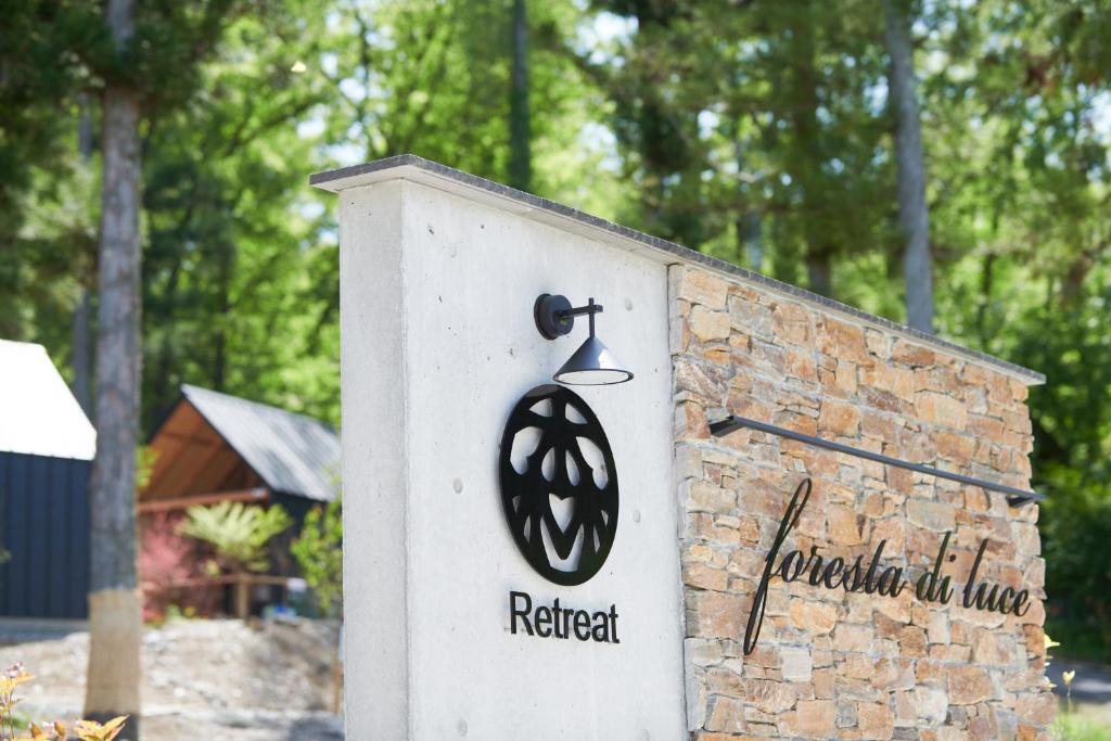 a sign for a retreat with a bell on it at 森のRetreat -foresta di luce- in Hatsukaichi
