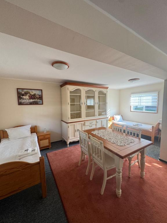 a room with a bed and a table and chairs at Domek Trapera in Smyczyna