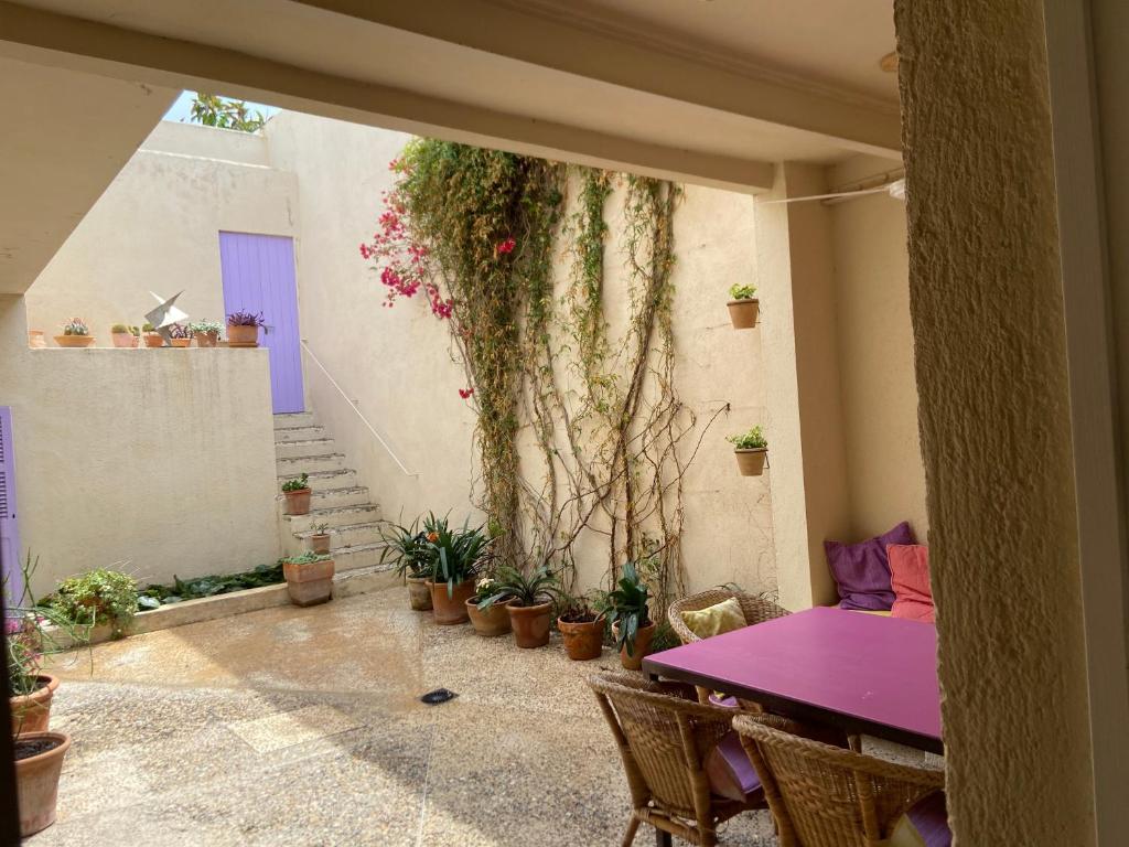 a purple table and chairs in a room with plants at Puerto de Cala Ratjada in Cala Ratjada