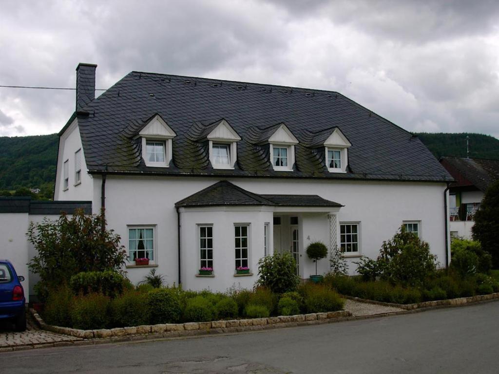 a white house with a black roof at Ferienapartment Weber-Loskill in Mehring