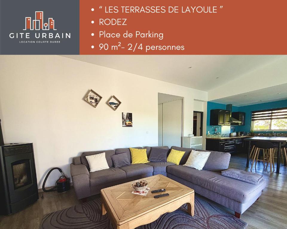 a living room with a couch and a table at Les TERRASSES DE LAYOULE in Rodez