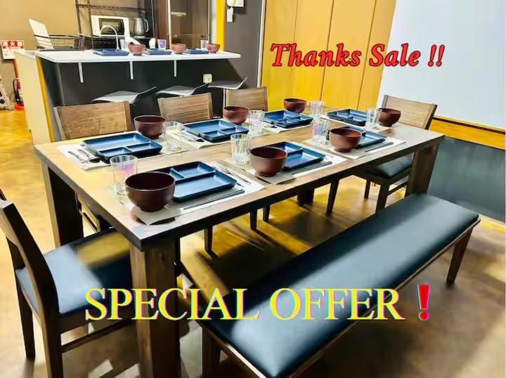 a table with plates and bowls on top of it at Matsuyamachi Dotonbori Condo in Osaka