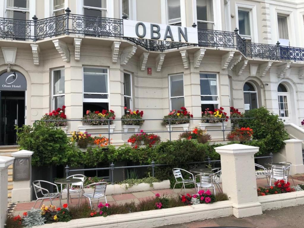 a building with tables and chairs in front of it at Oban Hotel in Eastbourne