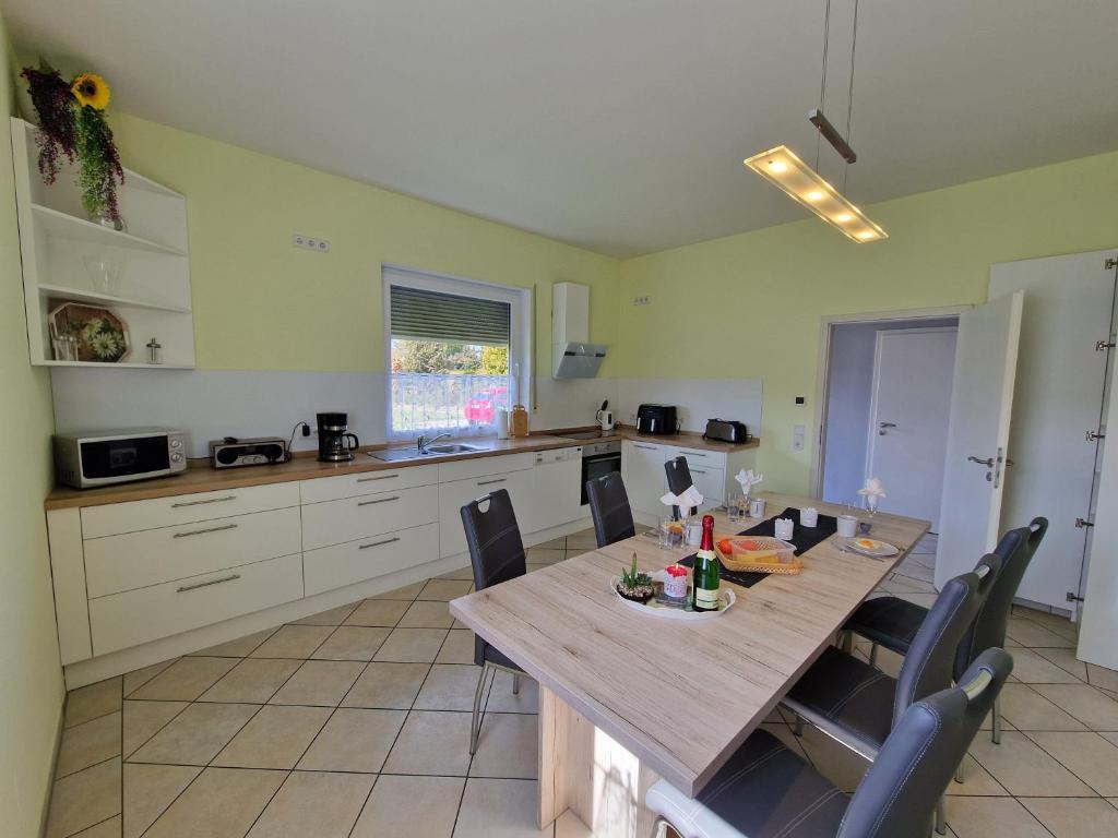 a kitchen with a wooden table and chairs in it at Ferienhaus Ruth in Walow