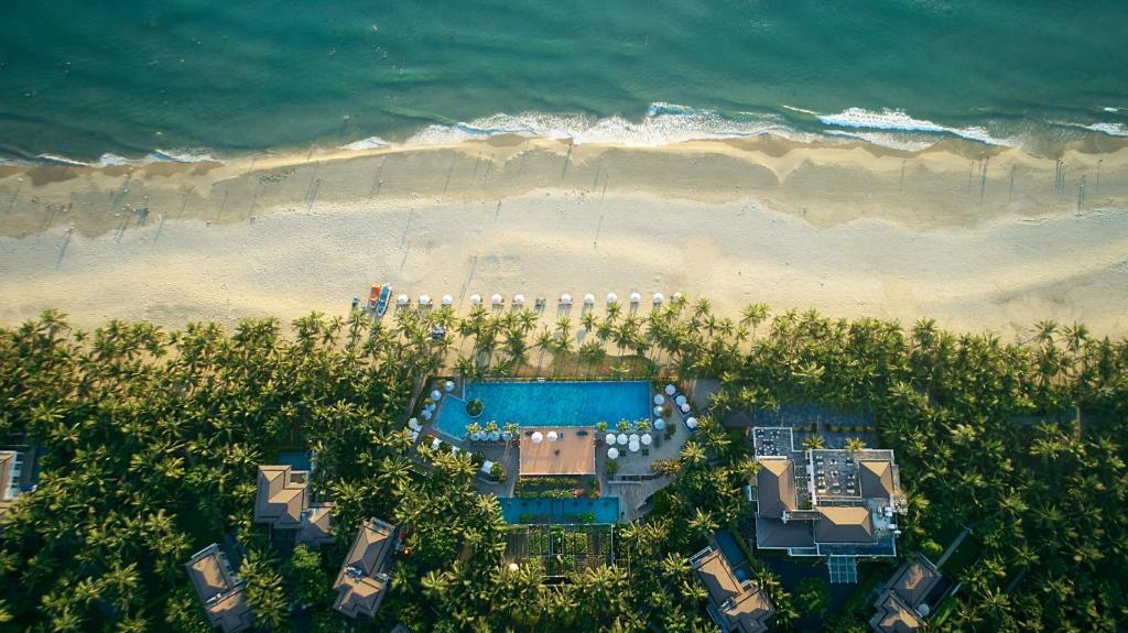 an aerial view of a beach with a swimming pool at Premier Villa Resort Danang in Danang