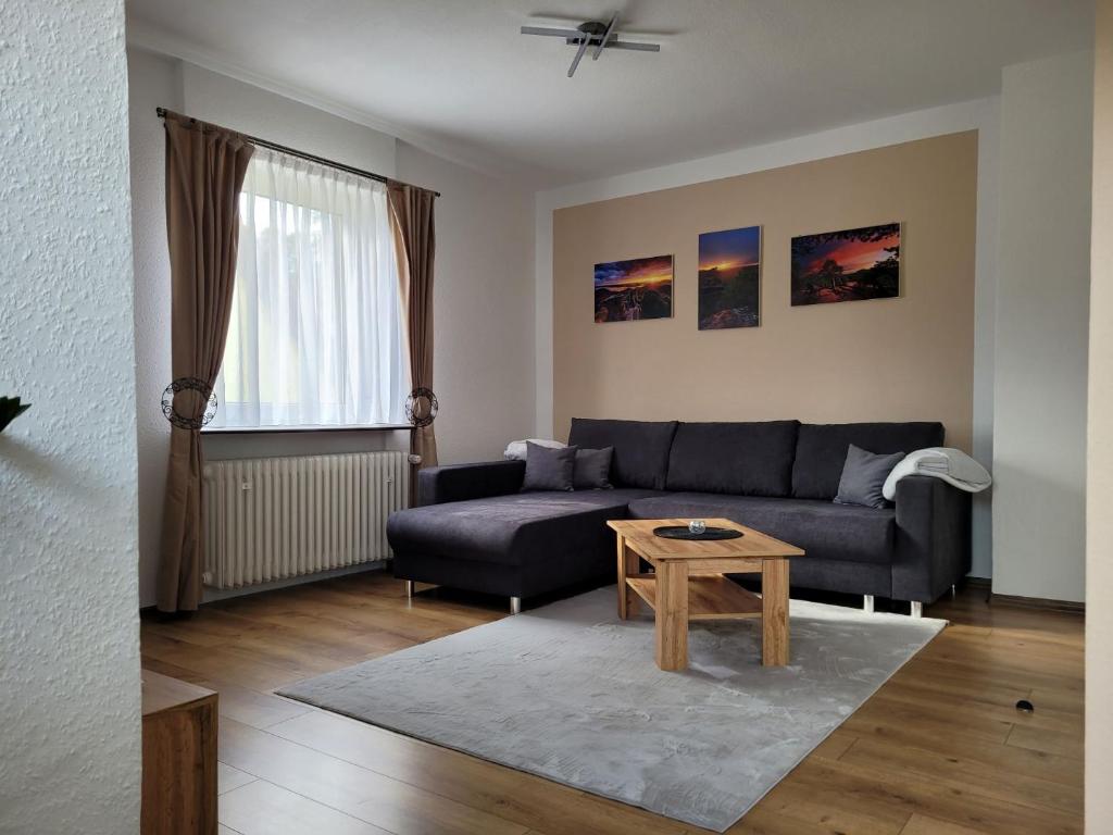 a living room with a couch and a table at Ferienwohnung Amano in Fischbach
