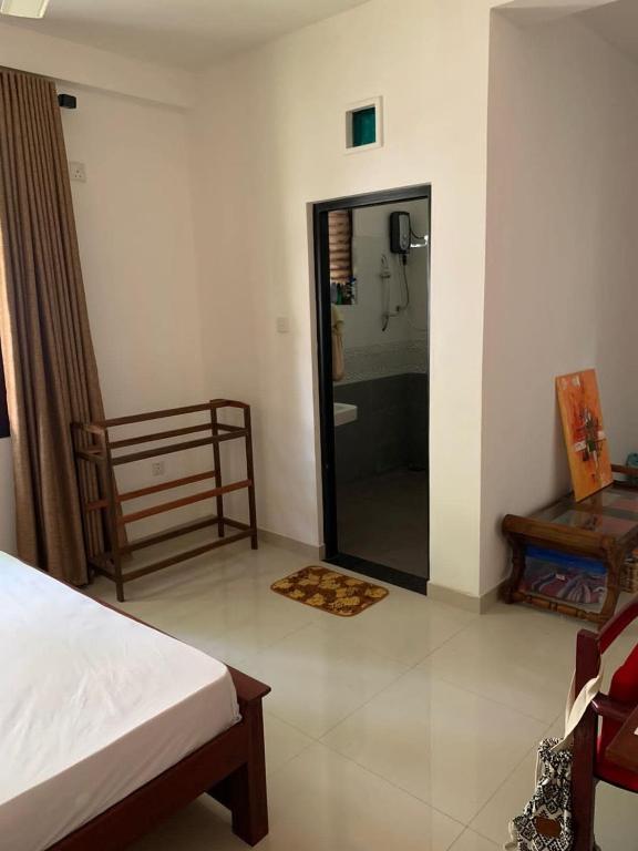 a bedroom with a shower and a bed and a mirror at AR 7 Villa Mirissa in Matara