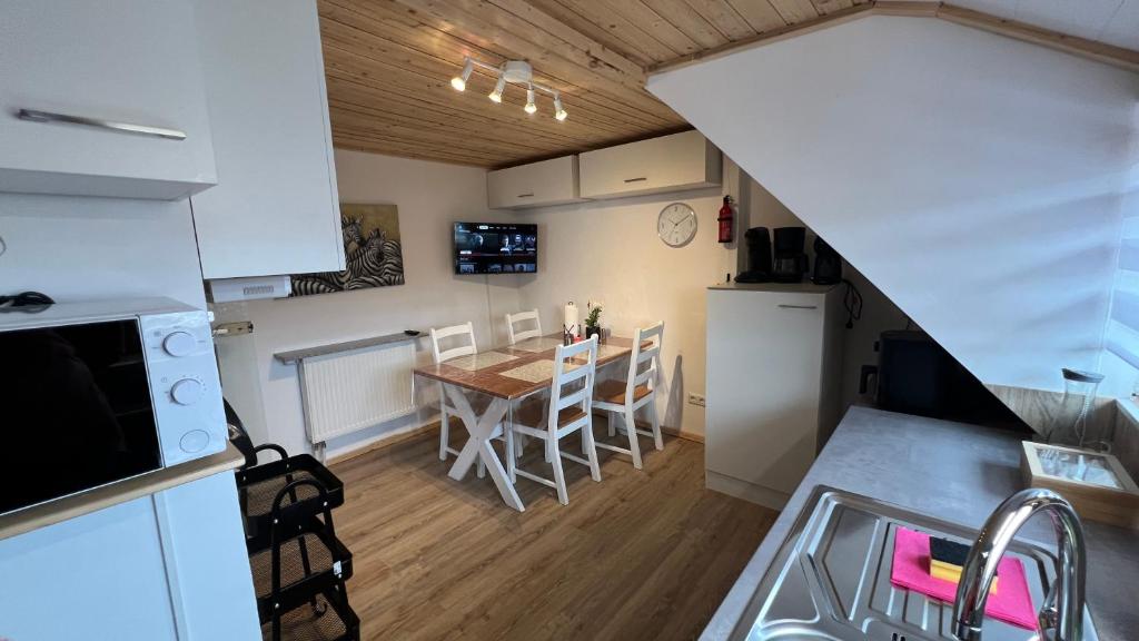 a kitchen and dining room with a table and chairs at D1 - Klein aber fein in Wernigerode