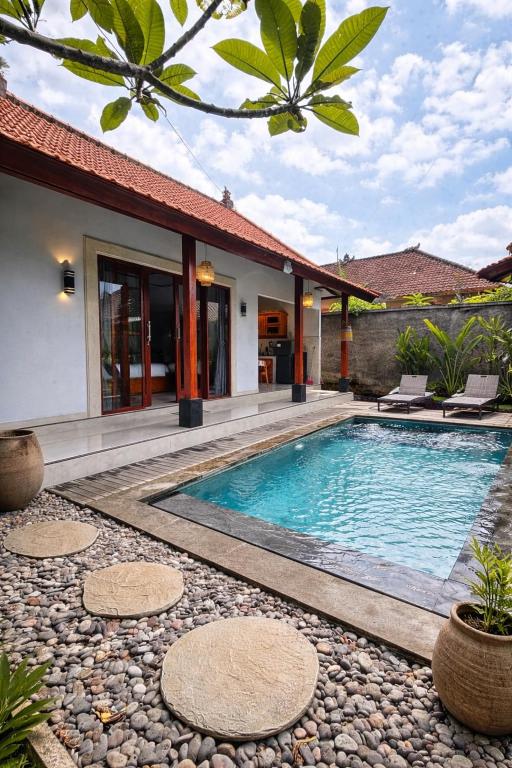 a swimming pool in the backyard of a villa at Molog private villa in Ubud