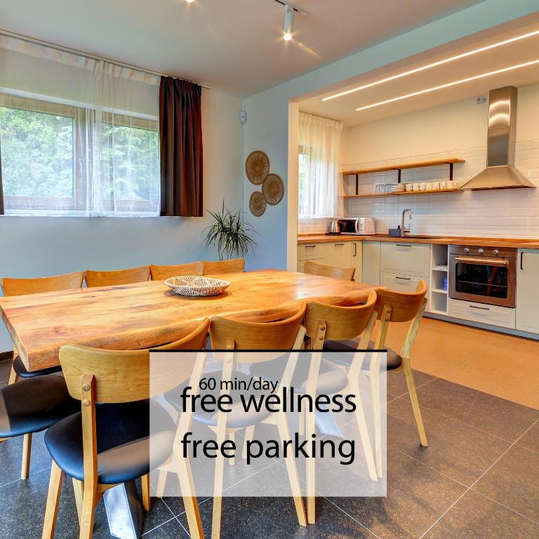 a kitchen with a large wooden table and chairs at Apartmány U stezek in Lipova Lazne