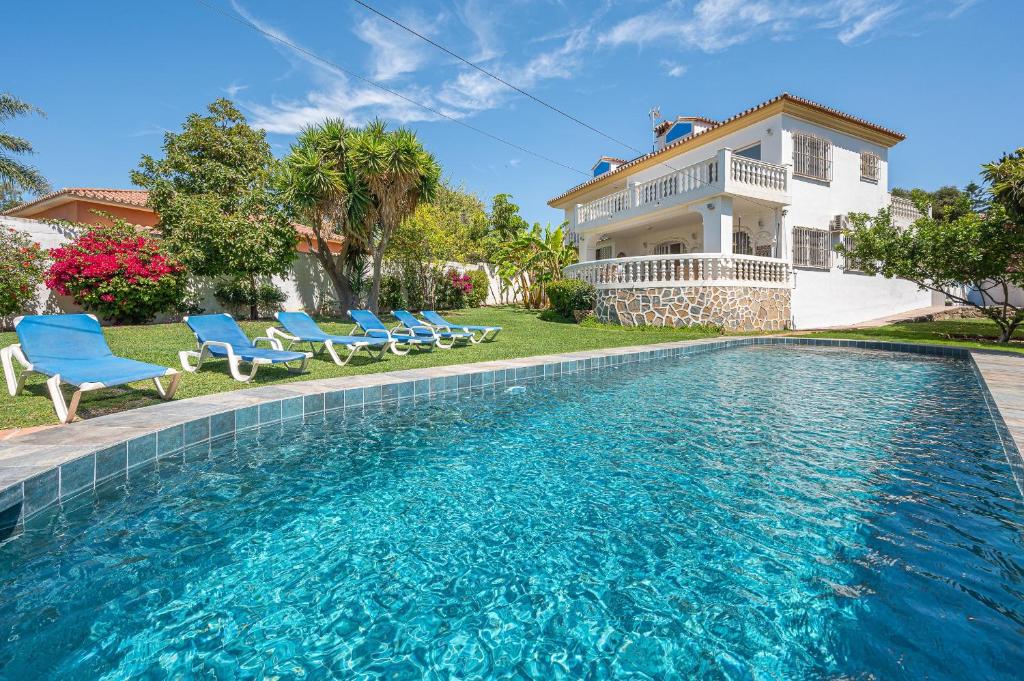 a house with a swimming pool in front of a house at Marbella Villa 16 Persons -Pool in Marbella