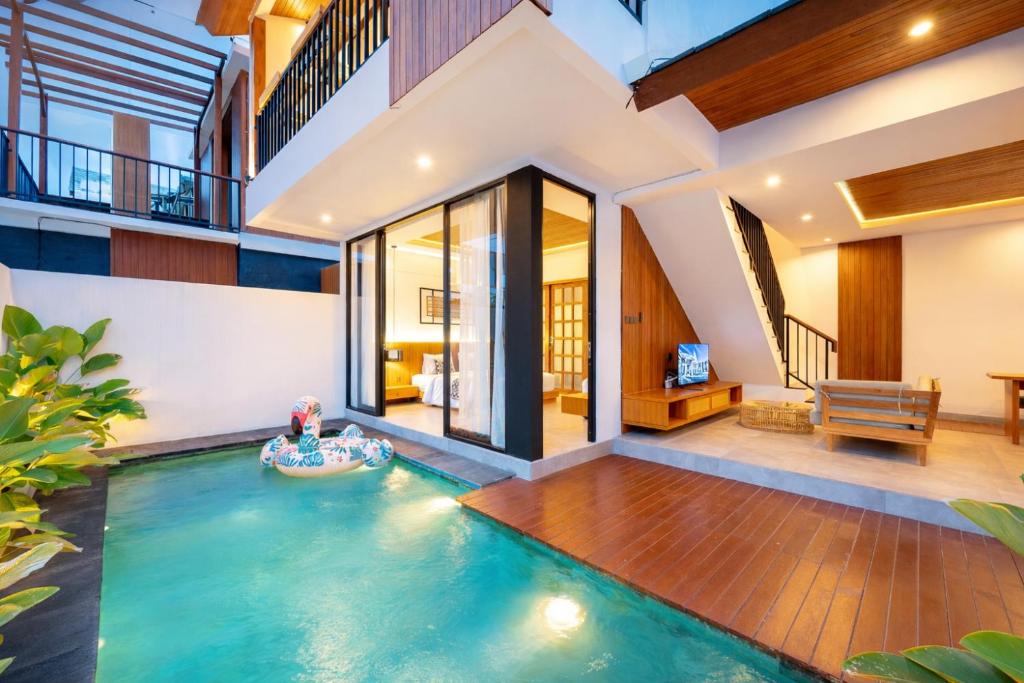 an indoor swimming pool in the middle of a house at Omkara Dharman Ubud Villa By Omkara Experience in Ubud