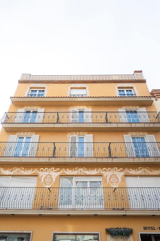 a building with balconies on the side of it at Hotel Tall de Conill in Capellades
