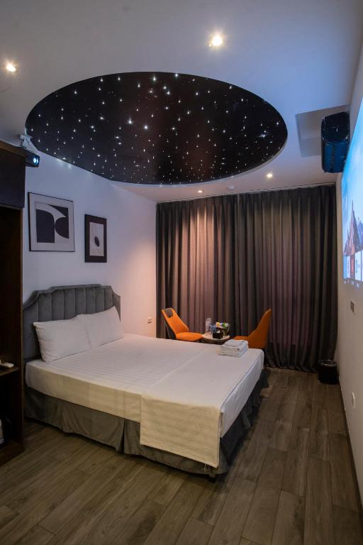 a bedroom with a bed with a star ceiling at Boutique Hotel in Hanoi