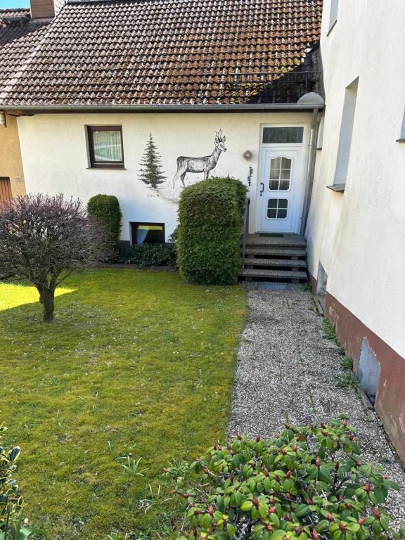 a painting of a deer on the side of a house at Pension Katharina im Solling in Holzminden