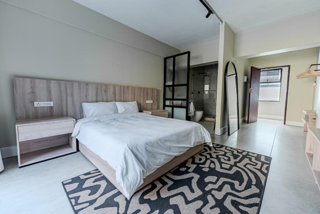 a bedroom with a large bed and a rug at inn here in Johannesburg