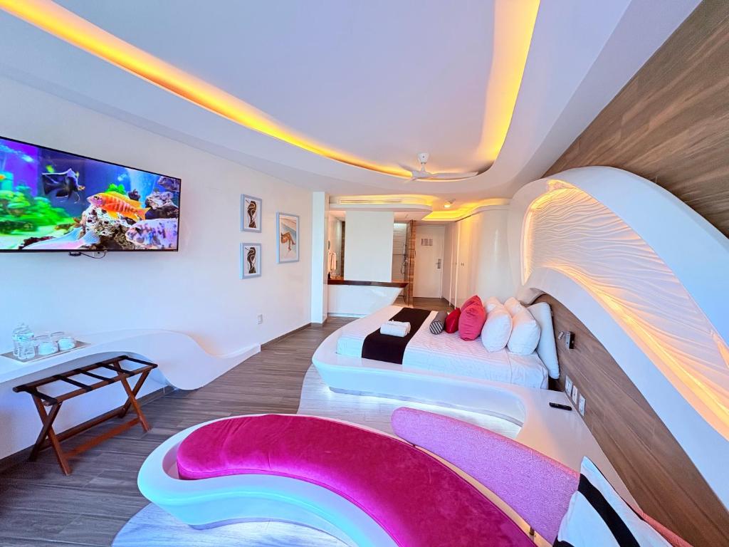 a bedroom with two beds in a room with a rainbow at Condohotel The Carmen Deluxe Oceanview King Suite in Playa del Carmen