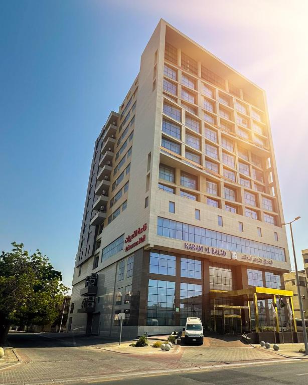 a tall building with a car parked in front of it at Karam Al Balad Hotel in Jeddah