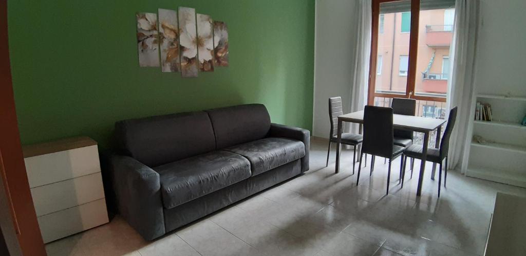a living room with a couch and a table at Casa Pirandello 3 min Metro in Sesto San Giovanni